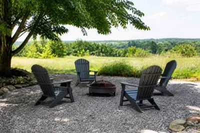 Low-maintenance outdoor seating area on a drained rural patio