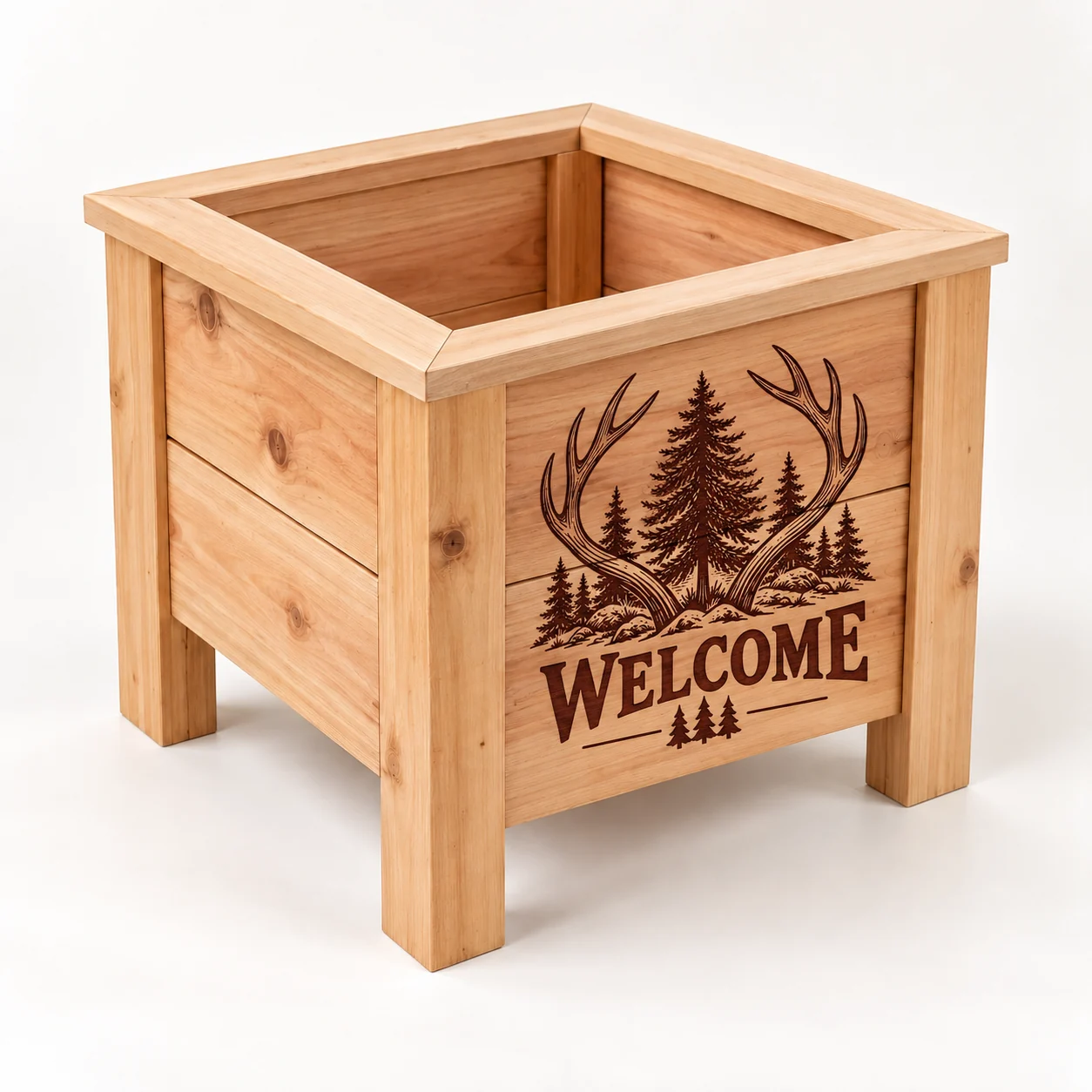 Antlers and pine trees surrounding a Welcome engraving on a small square cedar planter