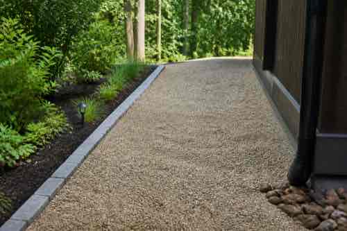 How Do You Maintain a Gravel Path or Pad in Summer? Raked gravel path with defined edges and drainage