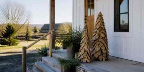 How Do You Choose Outdoor Décor That Fits a Rural Property? Handcrafted wood decor at a rural farmhouse entry