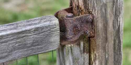 When Should You Repair or Replace an Outdoor Structure? Inspection of weathered outdoor structure hardware